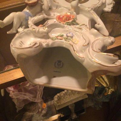 Porcelain clock with flowers and cherubs in working condition wind up clock