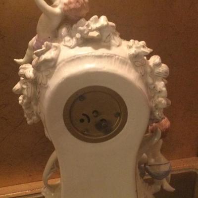 Porcelain clock with flowers and cherubs in working condition wind up clock