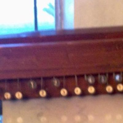 Stringed instrument with keys, wall hanger