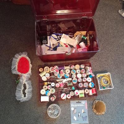 Plastic sewing box full of sewing notions, Thread, pin cushions, pins, and much more