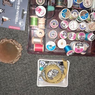 Plastic sewing box full of sewing notions, Thread, pin cushions, pins, and much more