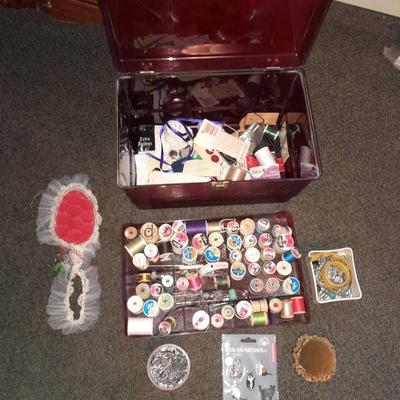 Plastic sewing box full of sewing notions, Thread, pin cushions, pins, and much more