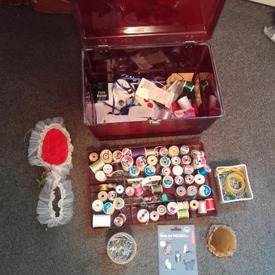 Plastic sewing box full of sewing notions, Thread, pin cushions, pins, and much more