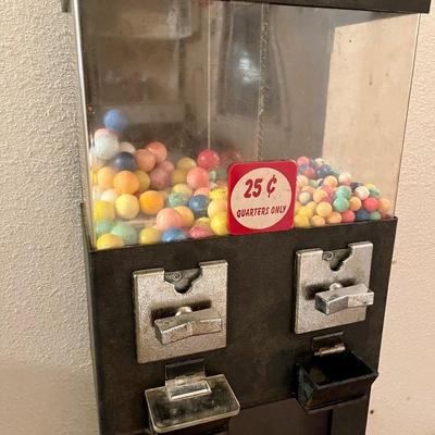 A double sided 25 cent gumball machine.