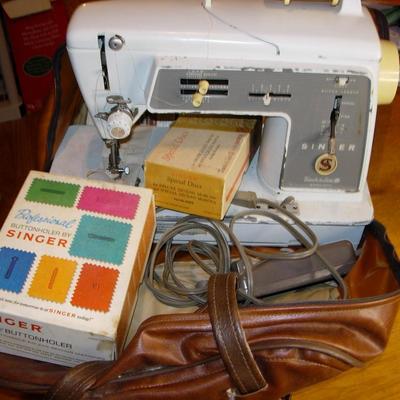 Vintage Singer sewing machine in original carrying bag.