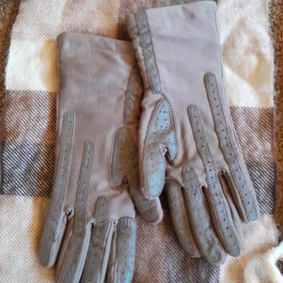 Brown toned winter wear, two scarves, an umbrella, fluffy socks, and a pair of gloves