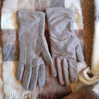 Brown toned winter wear, two scarves, an umbrella, fluffy socks, and a pair of gloves