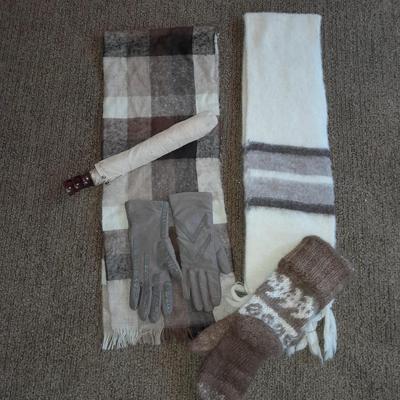Brown toned winter wear, two scarves, an umbrella, fluffy socks, and a pair of gloves