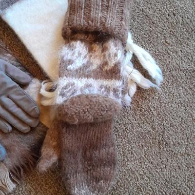 Brown toned winter wear, two scarves, an umbrella, fluffy socks, and a pair of gloves