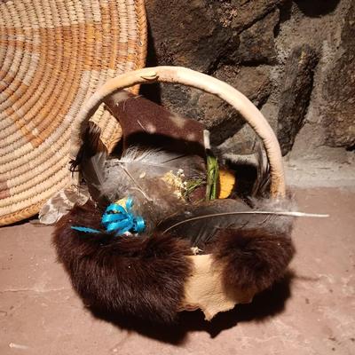 15" woven coil basket with small divination object basket decorated with feathers and fur