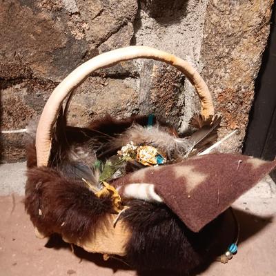 15" woven coil basket with small divination object basket decorated with feathers and fur