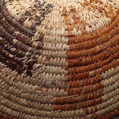 15" woven coil basket with small divination object basket decorated with feathers and fur