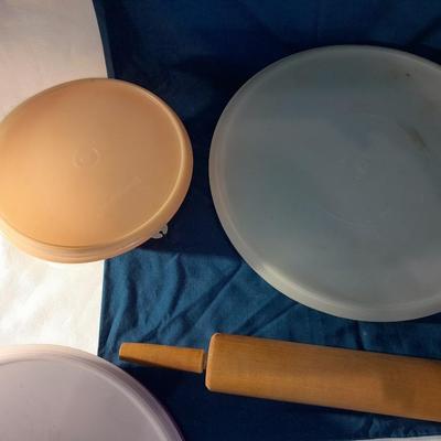 Lidded Tupperware storage containers and a wooden Rolling pin