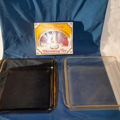 Two glass Pyrex baking dishes and a fancy pastry decorating set