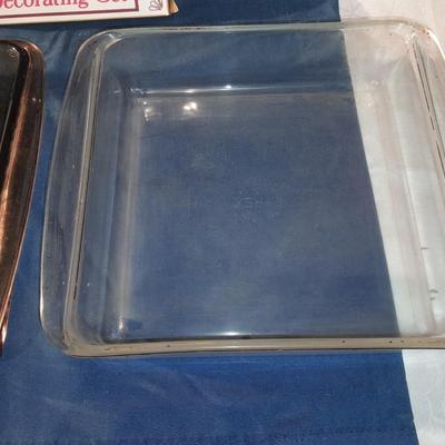 Two glass Pyrex baking dishes and a fancy pastry decorating set