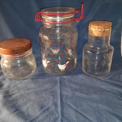 Three glass canisters with lids