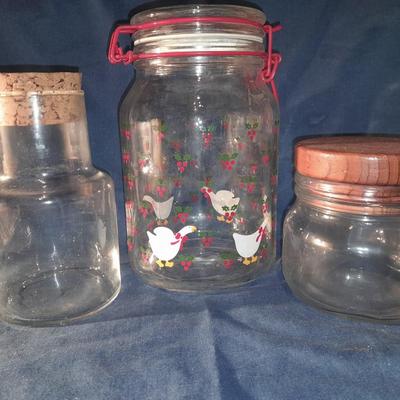 Three glass canisters with lids