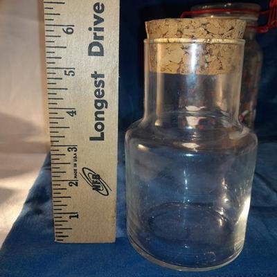 Three glass canisters with lids