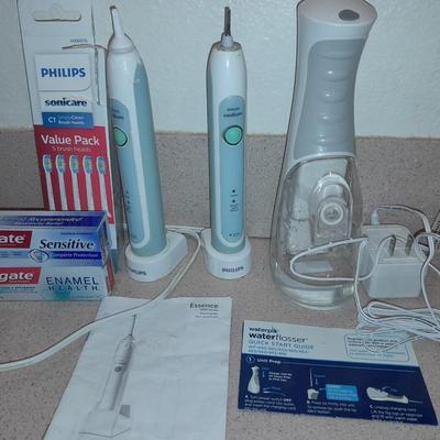 Rechargeable electric toothbrushes with heads and waterpik rinse aide