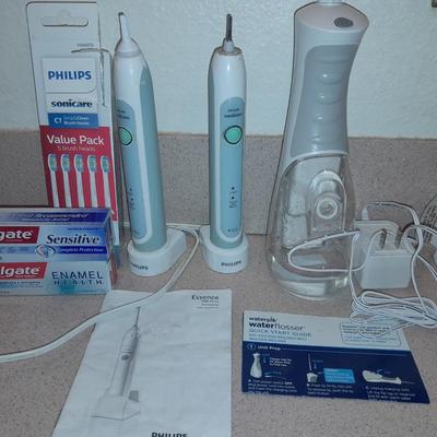 Rechargeable electric toothbrushes with heads and waterpik rinse aide