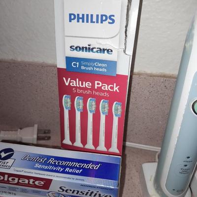 Rechargeable electric toothbrushes with heads and waterpik rinse aide