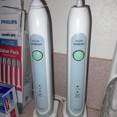 Rechargeable electric toothbrushes with heads and waterpik rinse aide