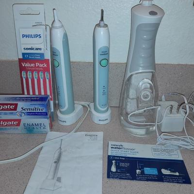 Rechargeable electric toothbrushes with heads and waterpik rinse aide