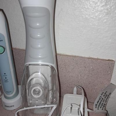 Rechargeable electric toothbrushes with heads and waterpik rinse aide