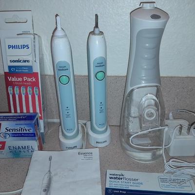 Rechargeable electric toothbrushes with heads and waterpik rinse aide