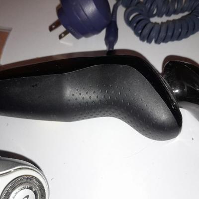Two Phillips Norelco Electric Razors with charger