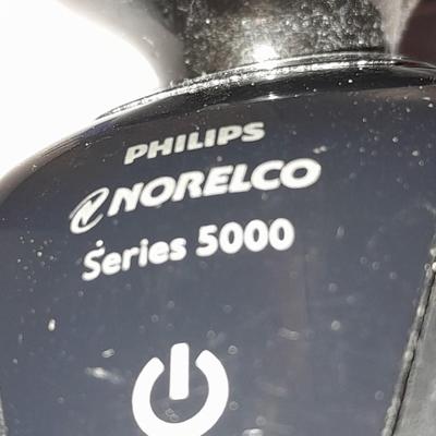 Two Phillips Norelco Electric Razors with charger
