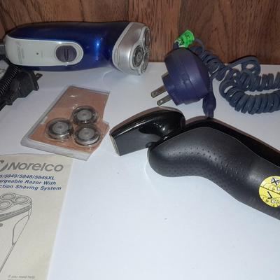 Two Phillips Norelco Electric Razors with charger