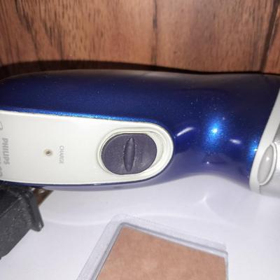 Two Phillips Norelco Electric Razors with charger