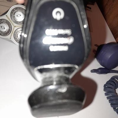 Two Phillips Norelco Electric Razors with charger