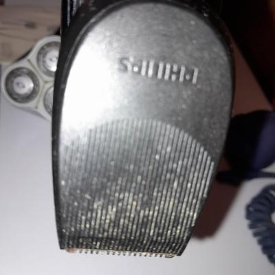Two Phillips Norelco Electric Razors with charger