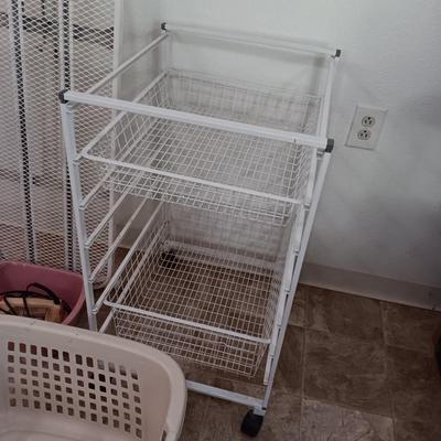 Metal Ironing board with metal baskets on stand and a clothing Iron