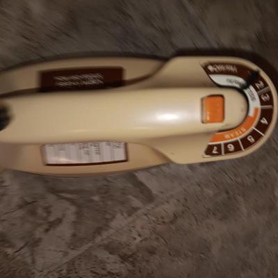 Metal Ironing board with metal baskets on stand and a clothing Iron