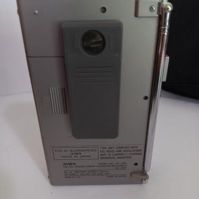 Portable Sony CD Car Discman with remote and vehicle attachments, a pair of Realistic speakers with case, and a Aiwa Walkman