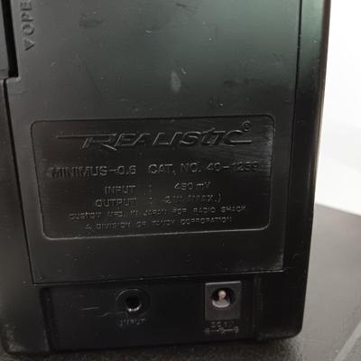Portable Sony CD Car Discman with remote and vehicle attachments, a pair of Realistic speakers with case, and a Aiwa Walkman