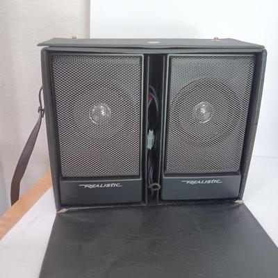Portable Sony CD Car Discman with remote and vehicle attachments, a pair of Realistic speakers with case, and a Aiwa Walkman