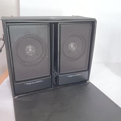 Portable Sony CD Car Discman with remote and vehicle attachments, a pair of Realistic speakers with case, and a Aiwa Walkman