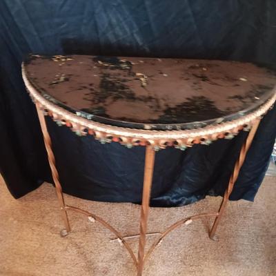 Ornate iron demilune console table with brown rock like top