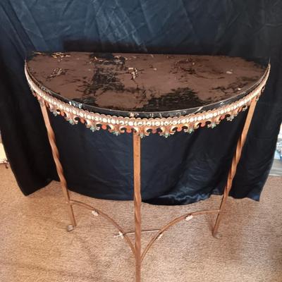 Ornate iron demilune console table with brown rock like top