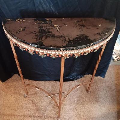 Ornate iron demilune console table with brown rock like top