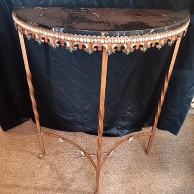 Ornate iron demilune console table with brown rock like top