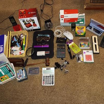 Assortment of office and school supplies including v tec cordless phones, personal fan and more