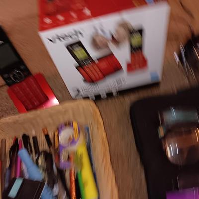 Assortment of office and school supplies including v tec cordless phones, personal fan and more