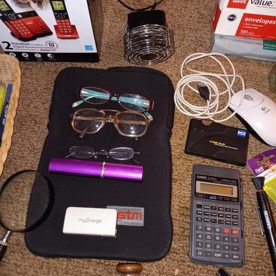 Assortment of office and school supplies including v tec cordless phones, personal fan and more