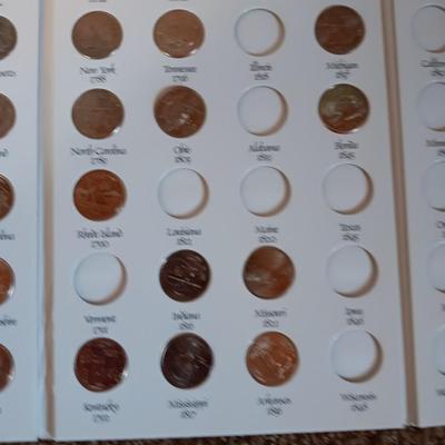 Preformed coin wrappers and a collection of United States quarters with map