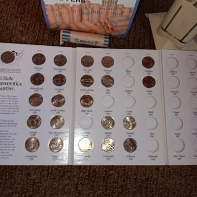 Preformed coin wrappers and a collection of United States quarters with map